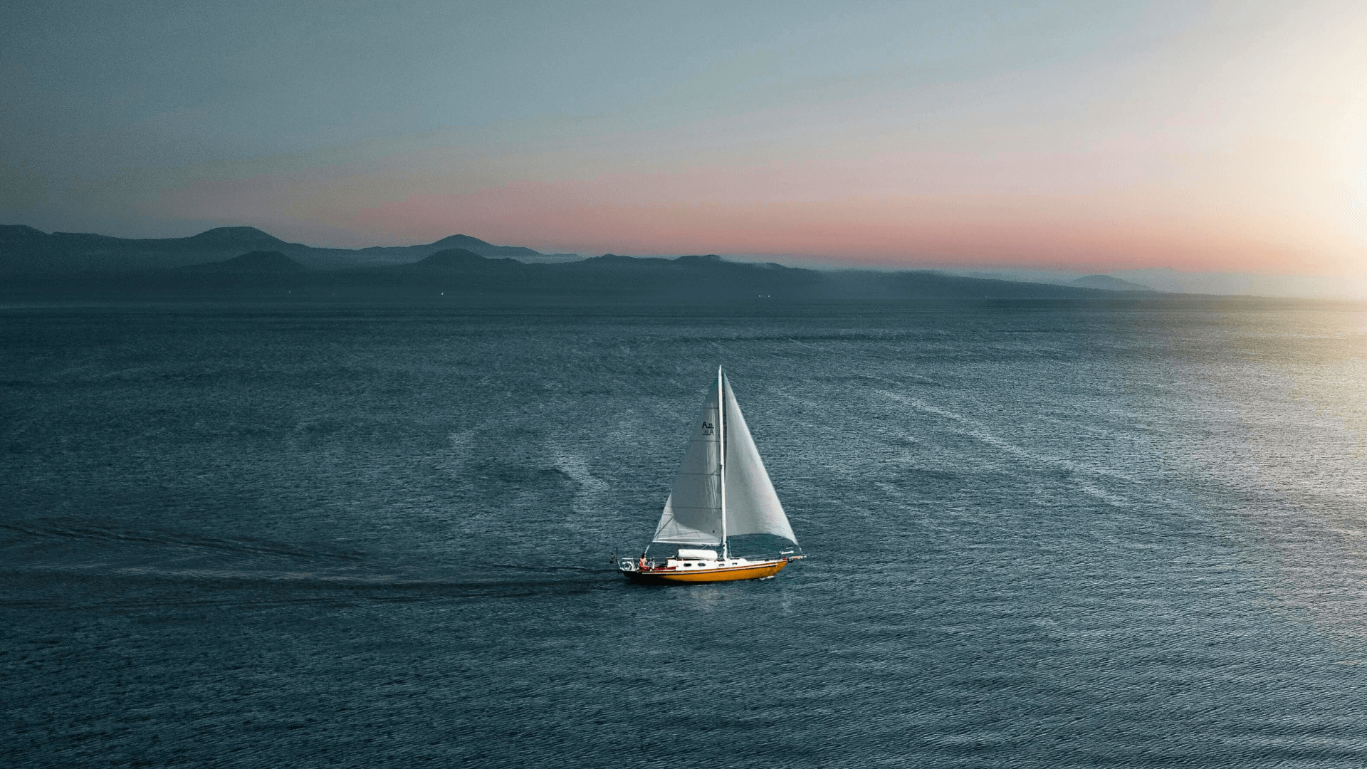 Sailboat on Lake Sevan at sunset, Armenia's pristine alpine lake offering sailing and recreation
